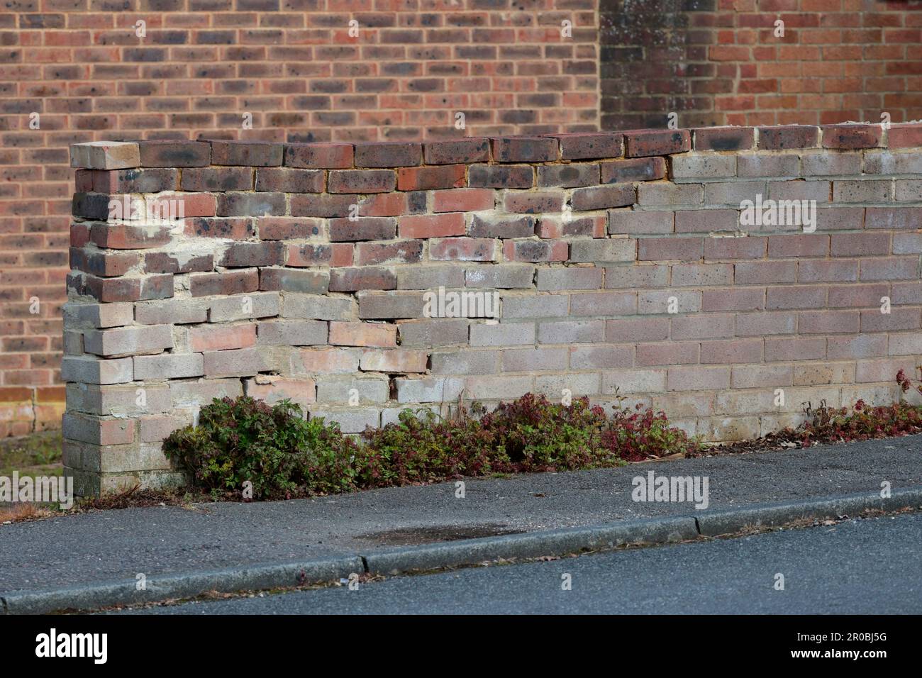 Brick laying badly an unsafe brick wall repair with loose and
