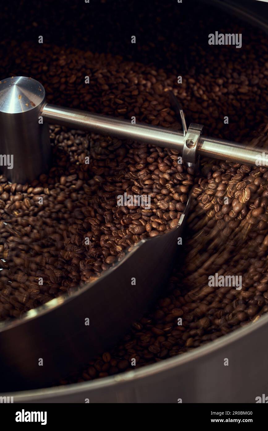 A cooling tray cools freshly roasted coffee from a coffee roaster. Stock Photo