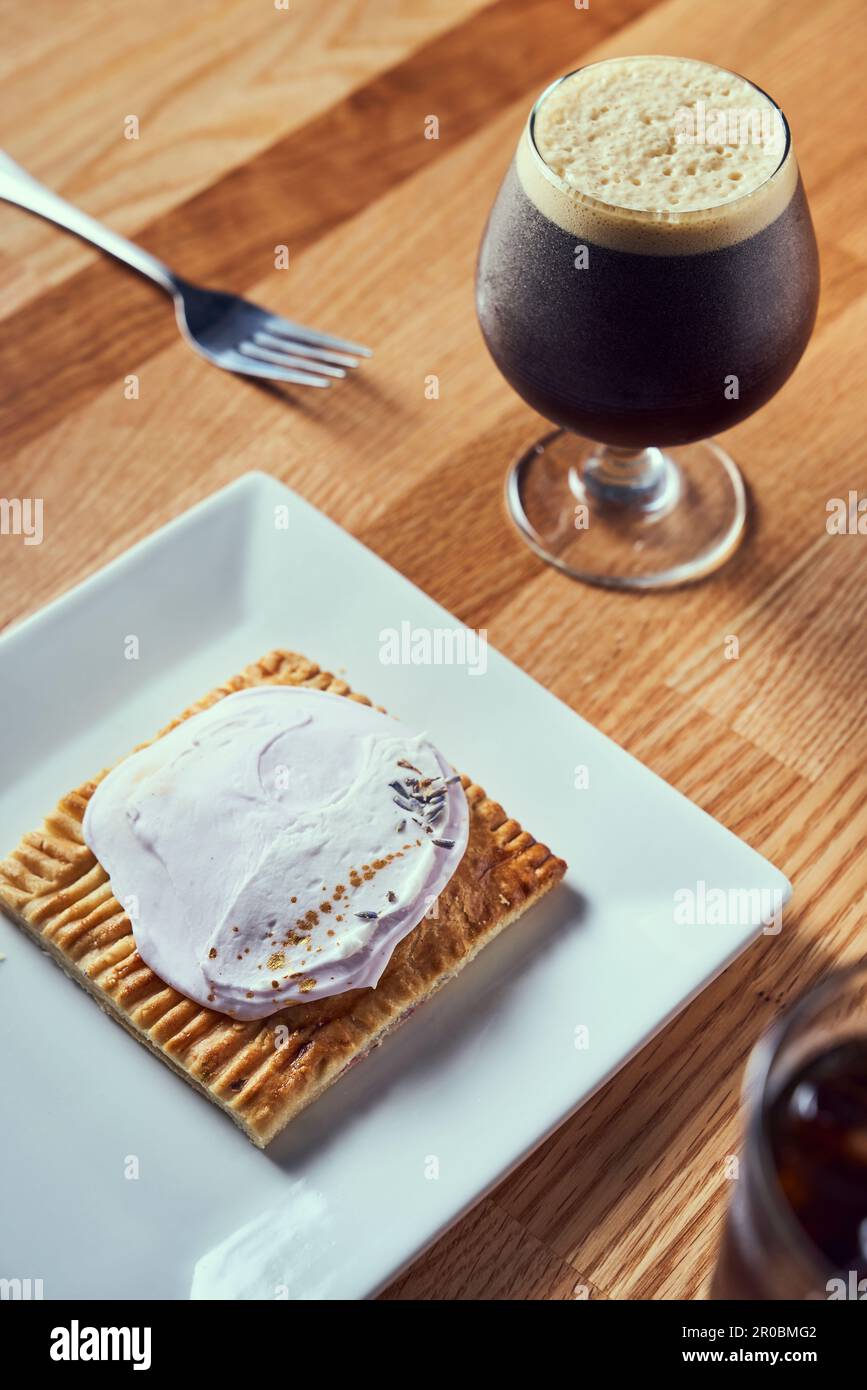 A nitro cold brew served with breakfast pastry. Stock Photo