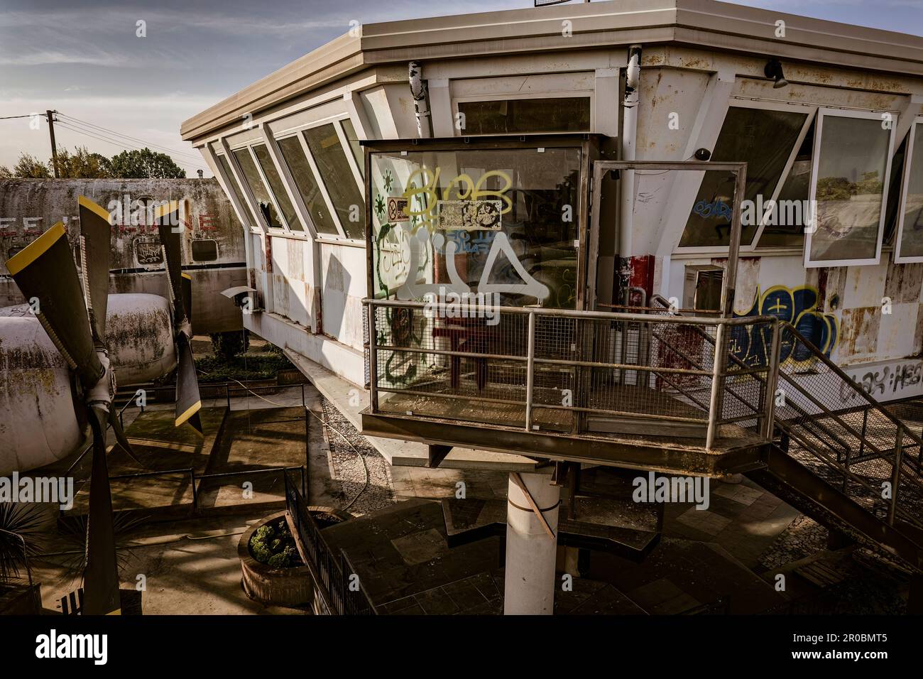 A haunting shot of an abandoned and vandalized airport control tower, left to decay and ruin. Stock Photo