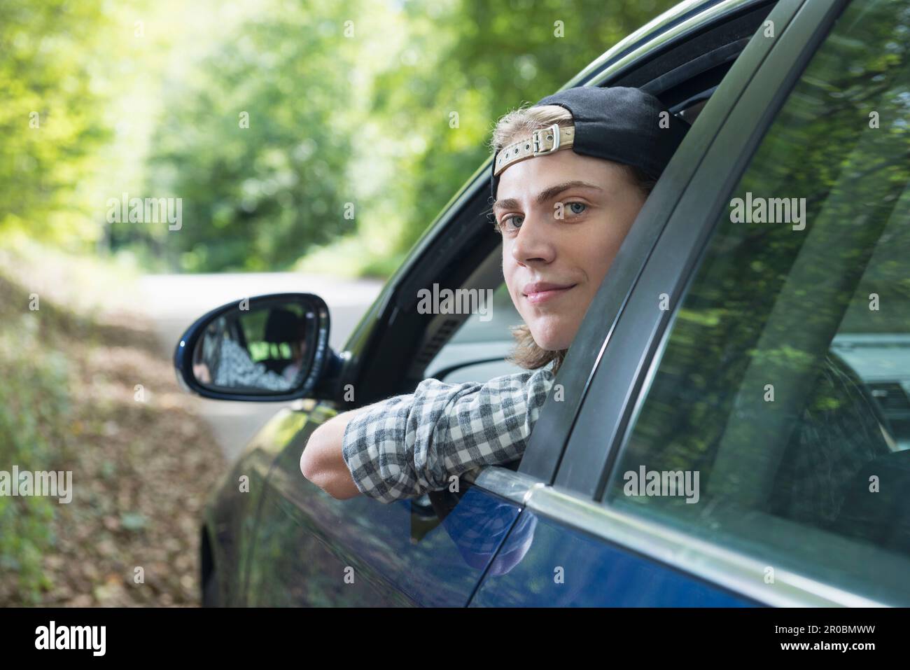 Teenage boy looking out of car window, Bavaria, Germany Stock Photo