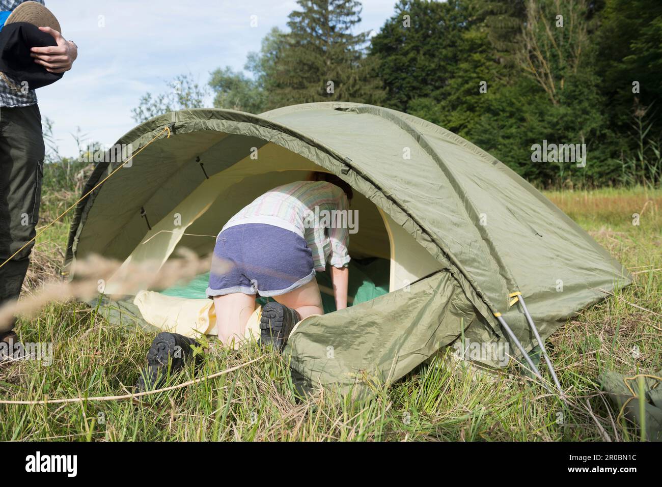 Young couple on camping and woman crawling in camp, Bavaria ,Germany