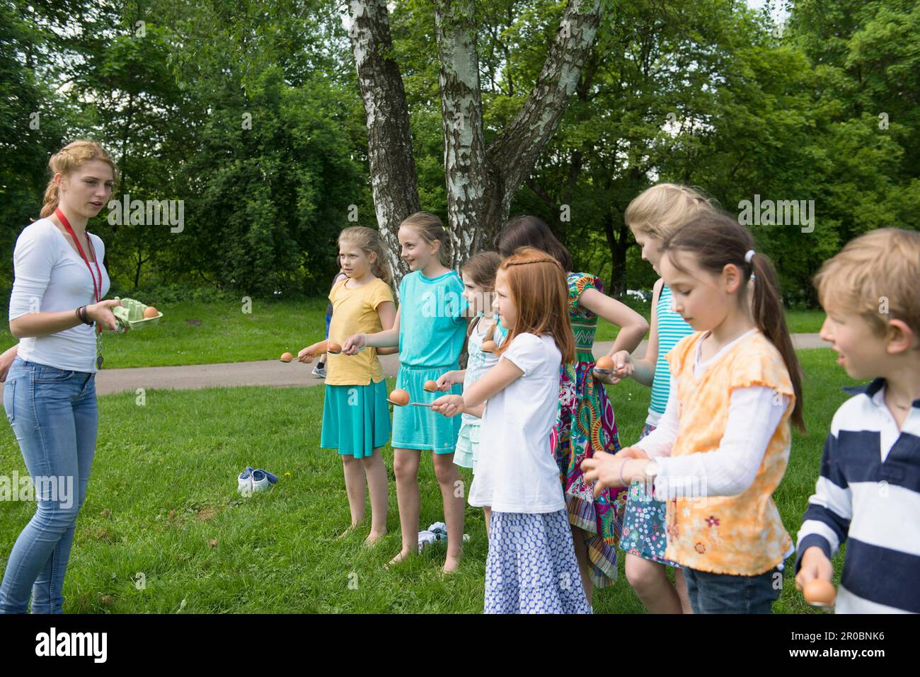 Female trainer instructing children to start the game, Munich, Bavaria, Germany Stock Photo