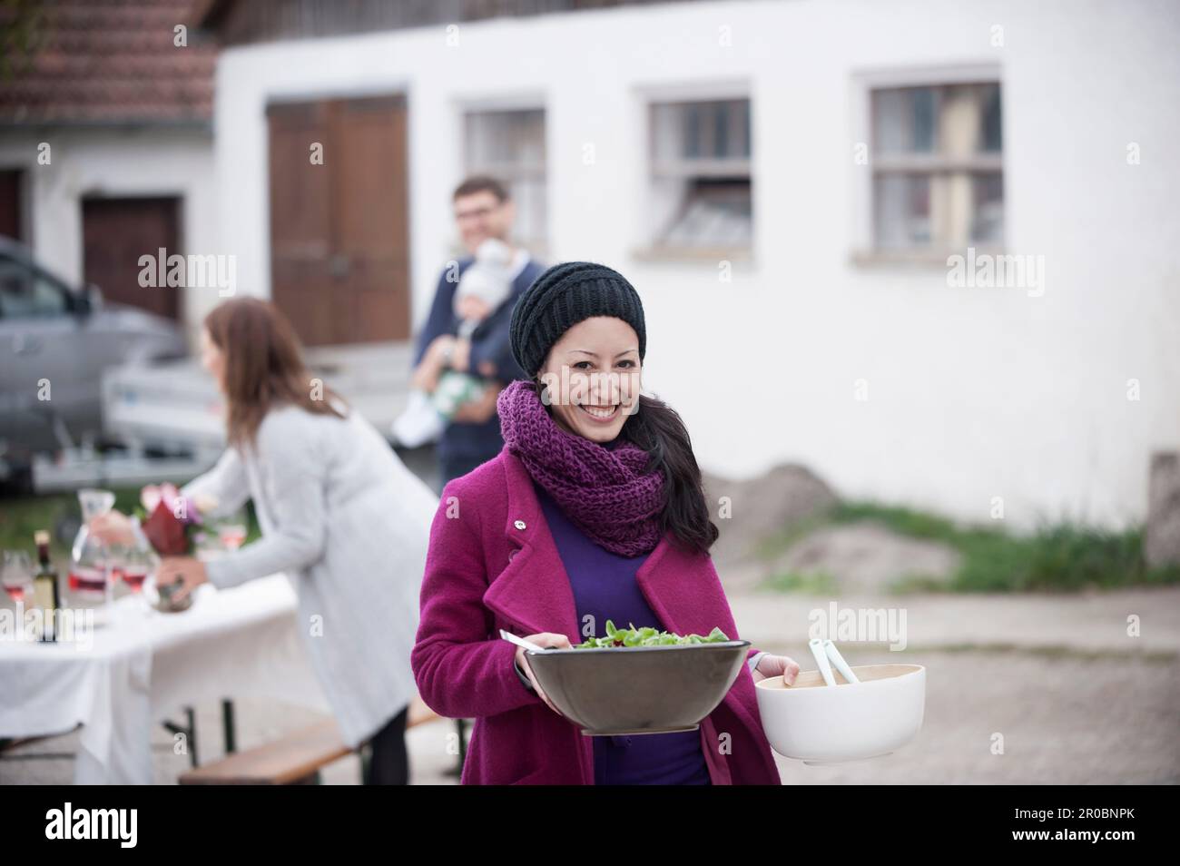 Mid adult woman holding salad bowl at farmhouse, Bavaria, Germany Stock Photo