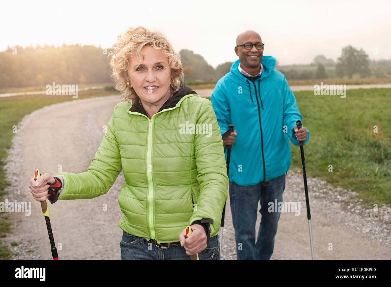 Senior couple hiking with hiking poles, Bavaria, Germany Stock Photo