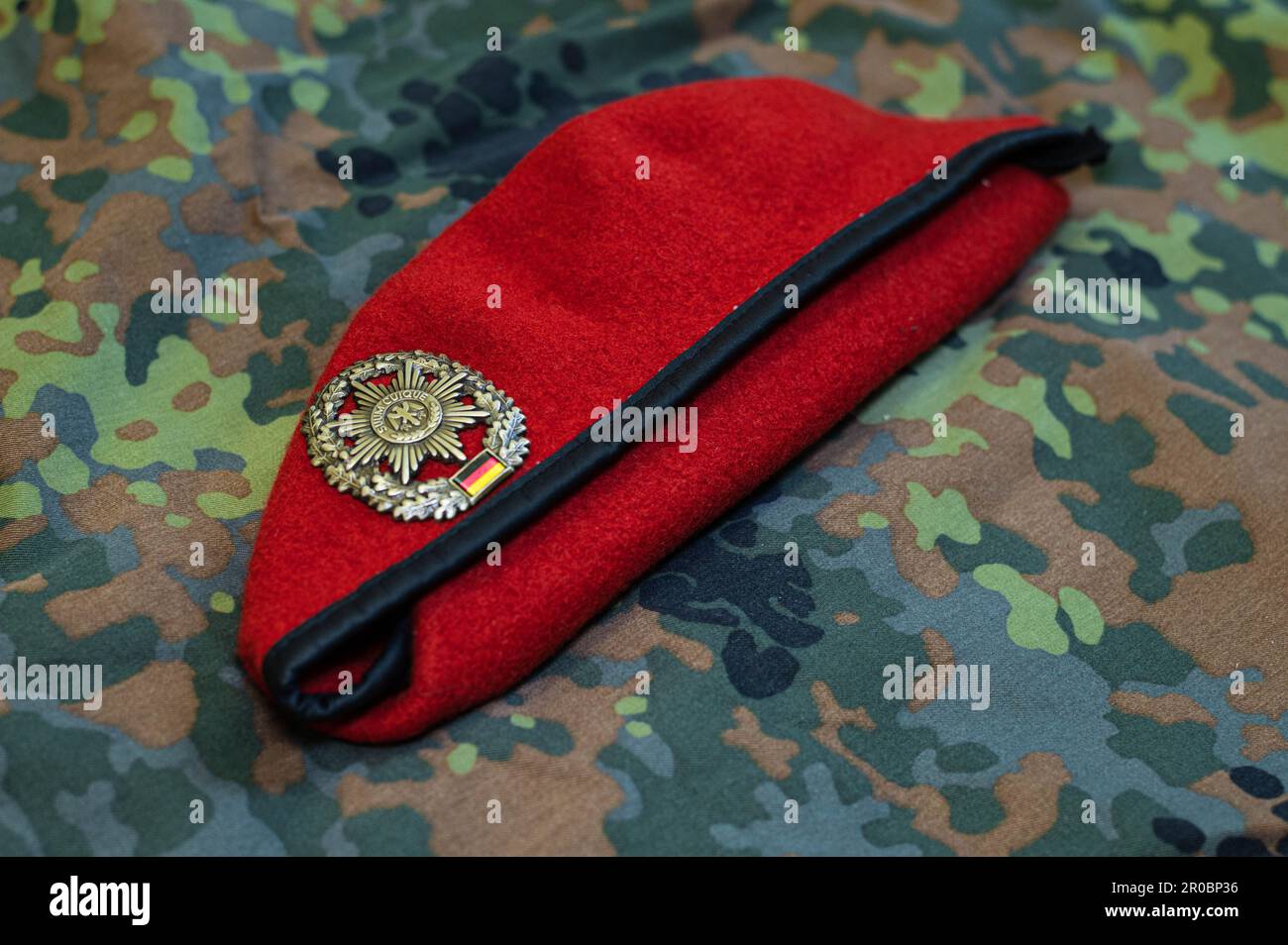 German Barett form military police with badge, German Uniform as background, Badge with Suum cuique Stock Photo
