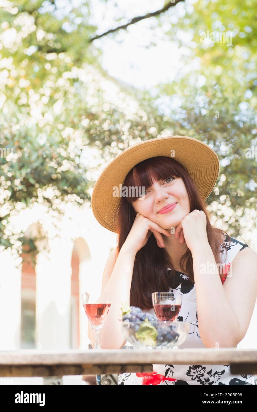 Beautiful woman sitting at outdoor restaurant Stock Photo - Alamy