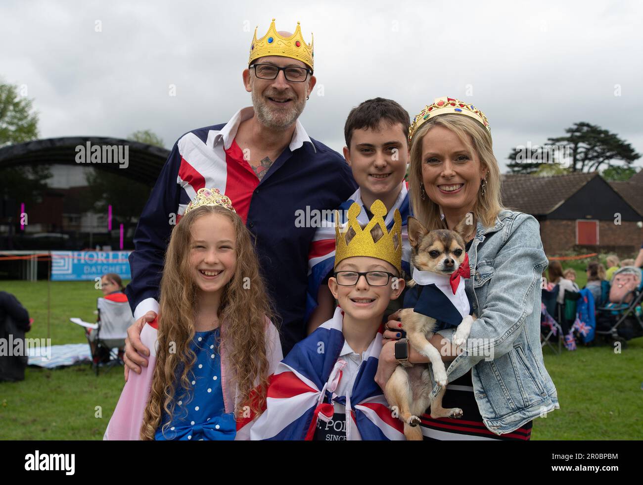 Datchet, Berkshire, UK. 7th May, 2023. The Allmark family and Tuco the dog at the Datchet Coronation Fete in Berkshire, Datchet. Credit: Maureen McLean/Alamy Live News Stock Photo