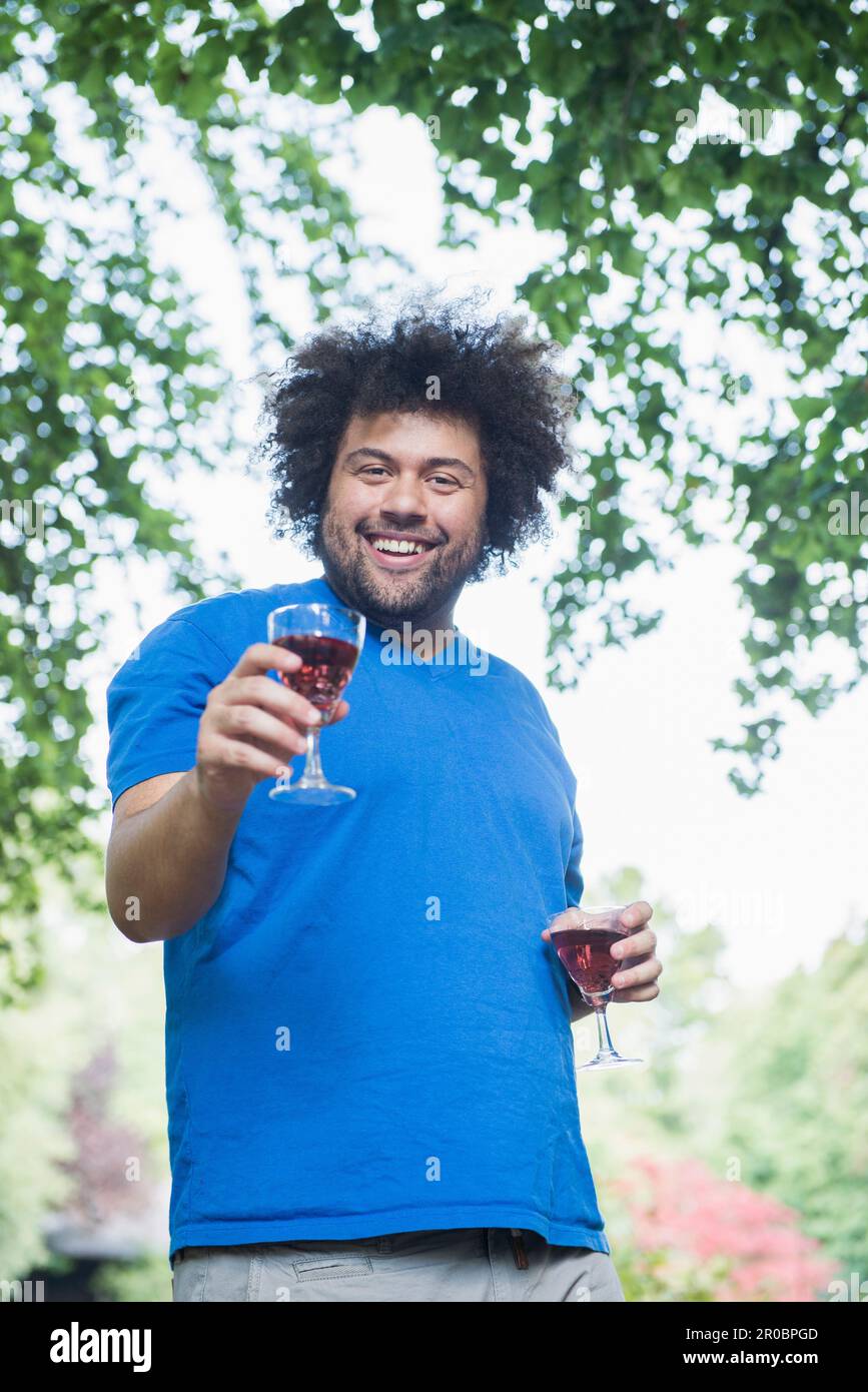 Happy young man outdoors with glass of wine Stock Photo