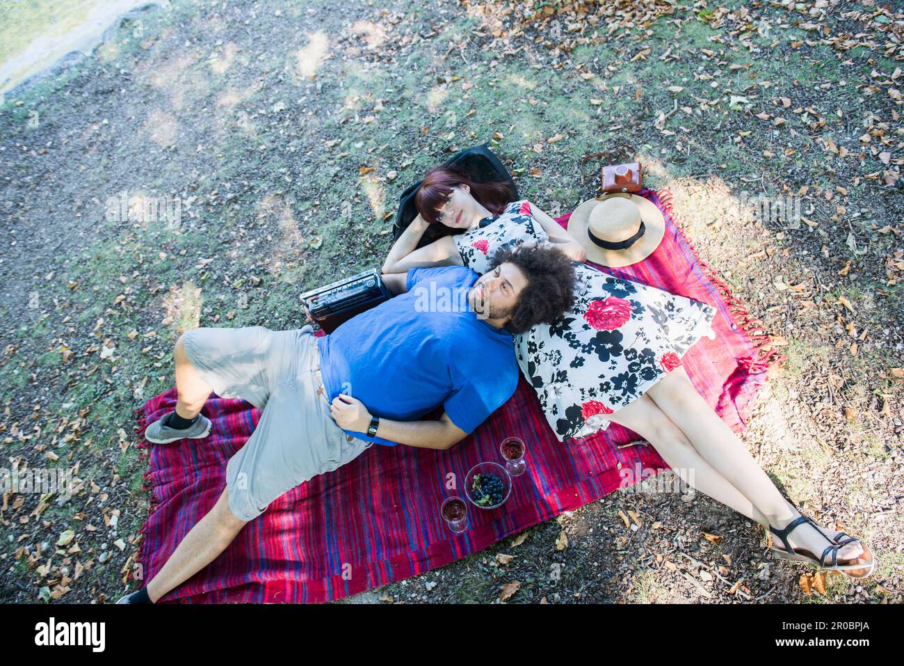 Young couple relaxing on picnic blanket Stock Photo
