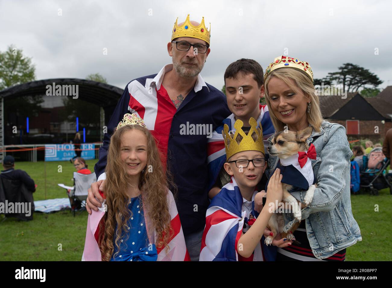 Datchet, Berkshire, UK. 7th May, 2023. The Allmark family and Tuco the dog at the Datchet Coronation Fete in Berkshire, Datchet. Credit: Maureen McLean/Alamy Live News Stock Photo