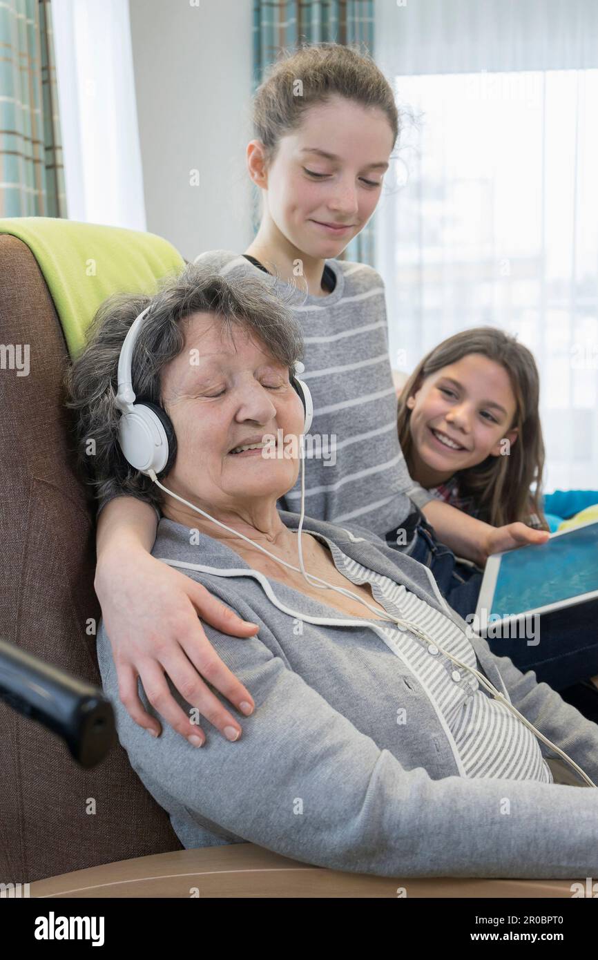Senior woman spending time with grand children in rest home Stock Photo