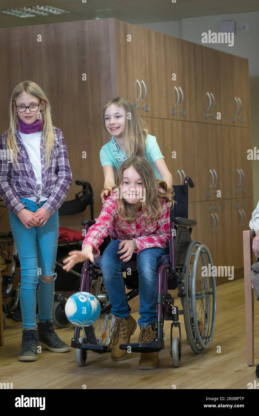 Girls playing bowling in rest home Stock Photo