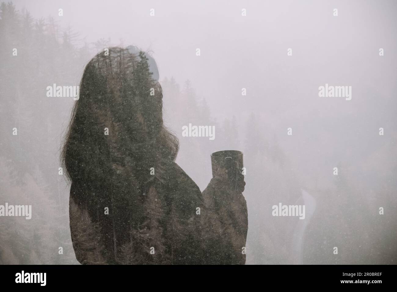 Double exposure female silhouette with a cup on mountains background Stock Photo