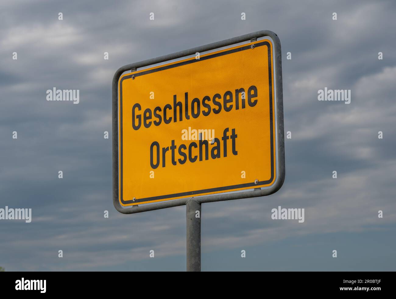 City entrance sign on a road in Germany with the text 'geschlossene Ortschaft' (built-up area). Stock Photo