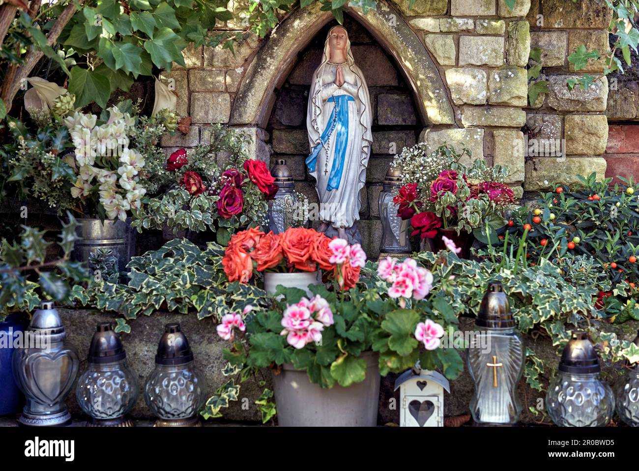 Statue of the Blessed Virgin Mary set inside a small enclave and ...