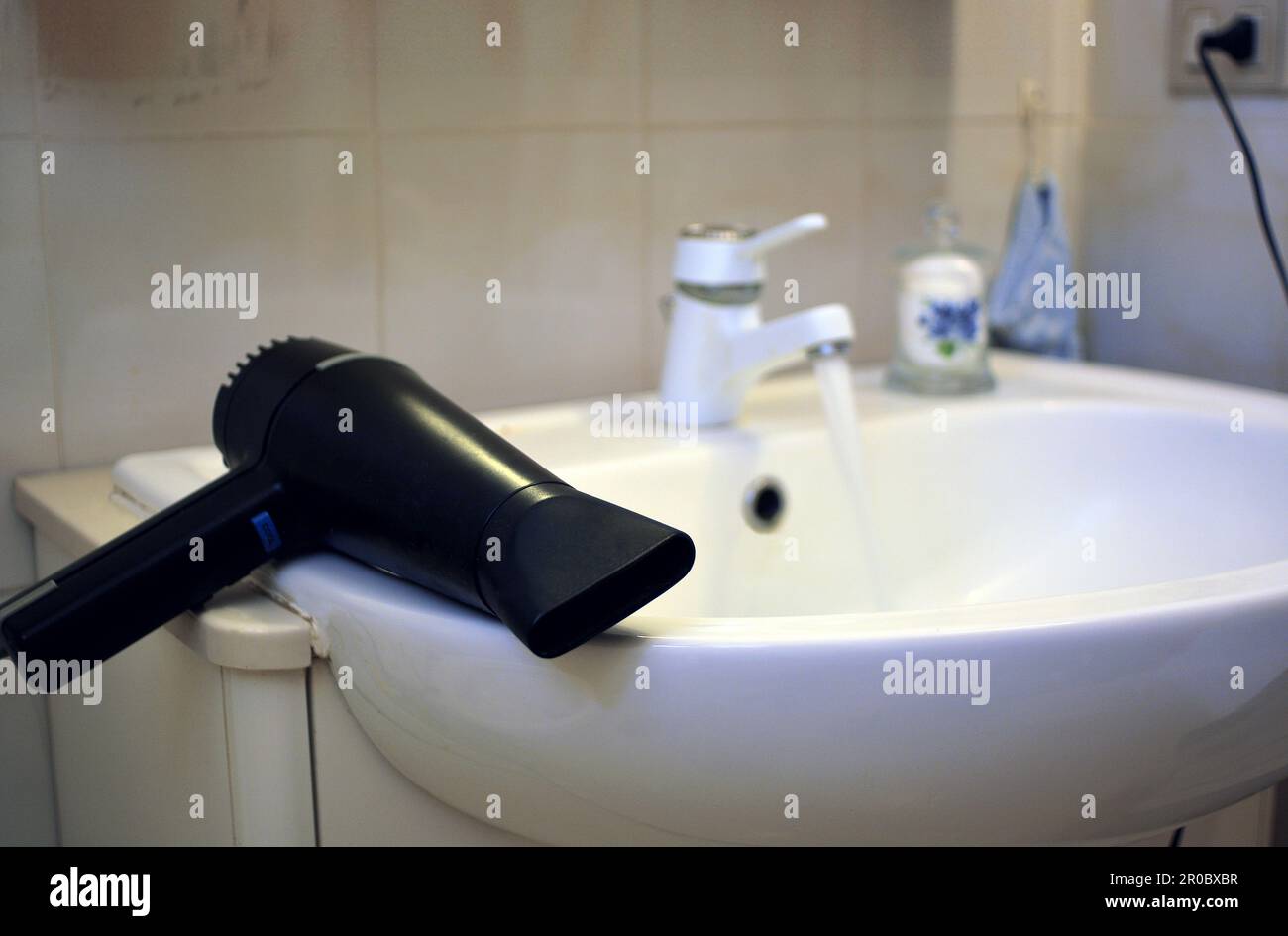 Domestic accidents, shock hazard with electricity and water Stock Photo