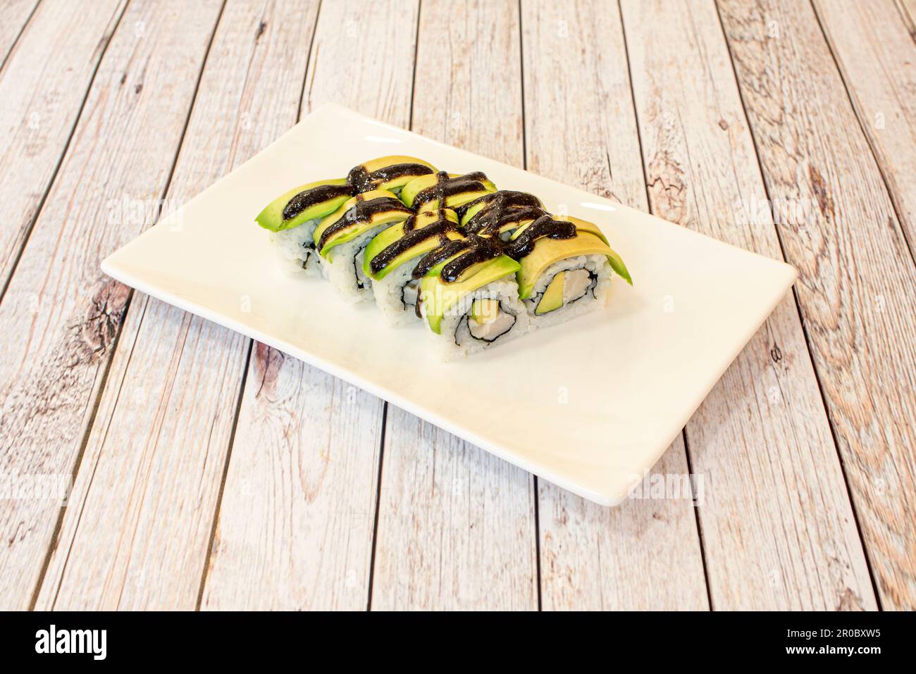 Uramaki california rice roll with nori seaweed, white fish and lots of avocado Stock Photo