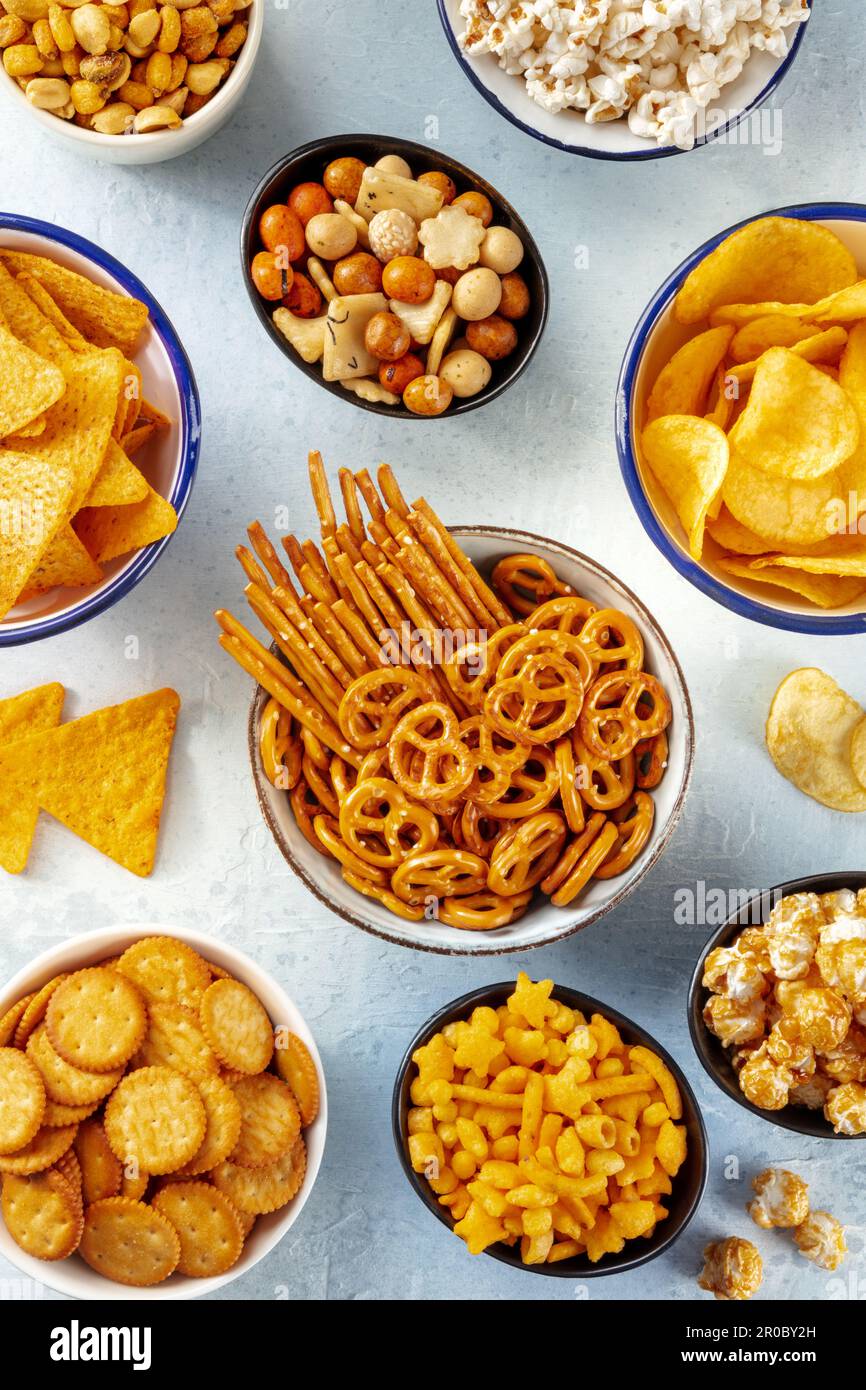 Salty snacks, party mix. A variety of crispy appetizers, shot from the top. Tortilla and potato