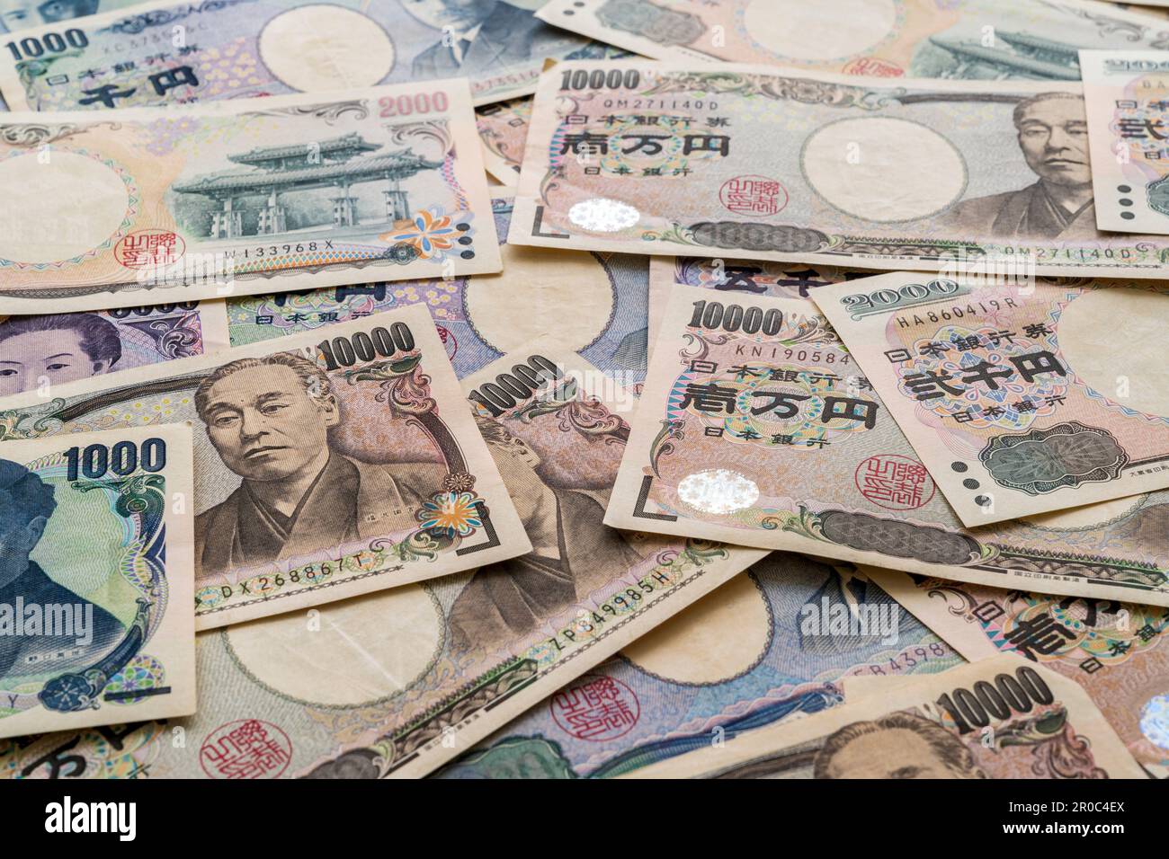 Japanese currency. View looking down at a pile of Japanese banknotes in various denominations, 1000, 2000, 5000,and 10,000 Yen Stock Photo