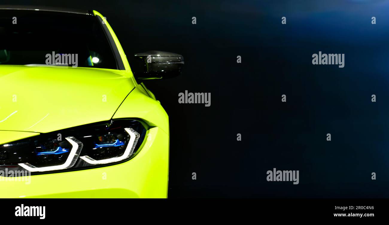 Front headlights of yellow sport car on black background,copy space Stock Photo