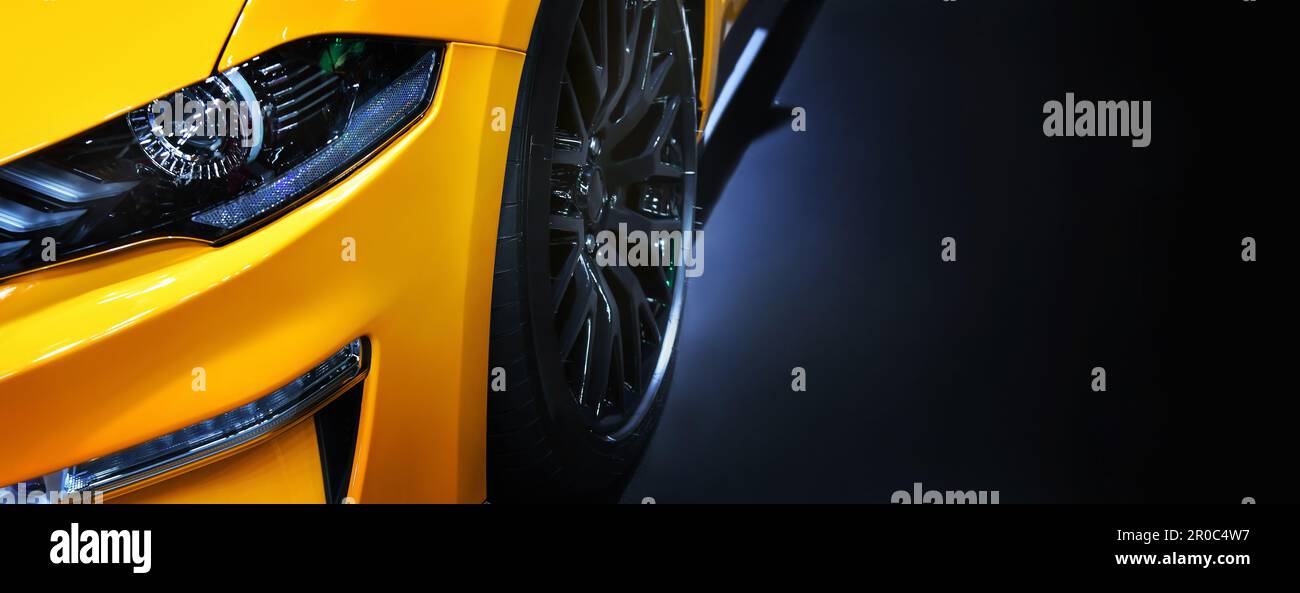 Front headlights of yellow sport car on black background,copy space Stock Photo