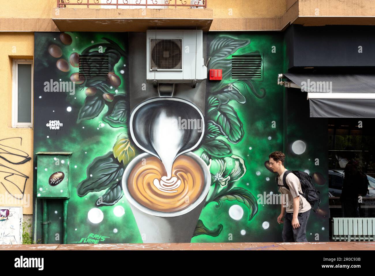 Graffiti street art painting of coffee making next to Starbucks coffee shop in Sofia, Bulgaria, Eastern Europe, Balkans, EU Stock Photo