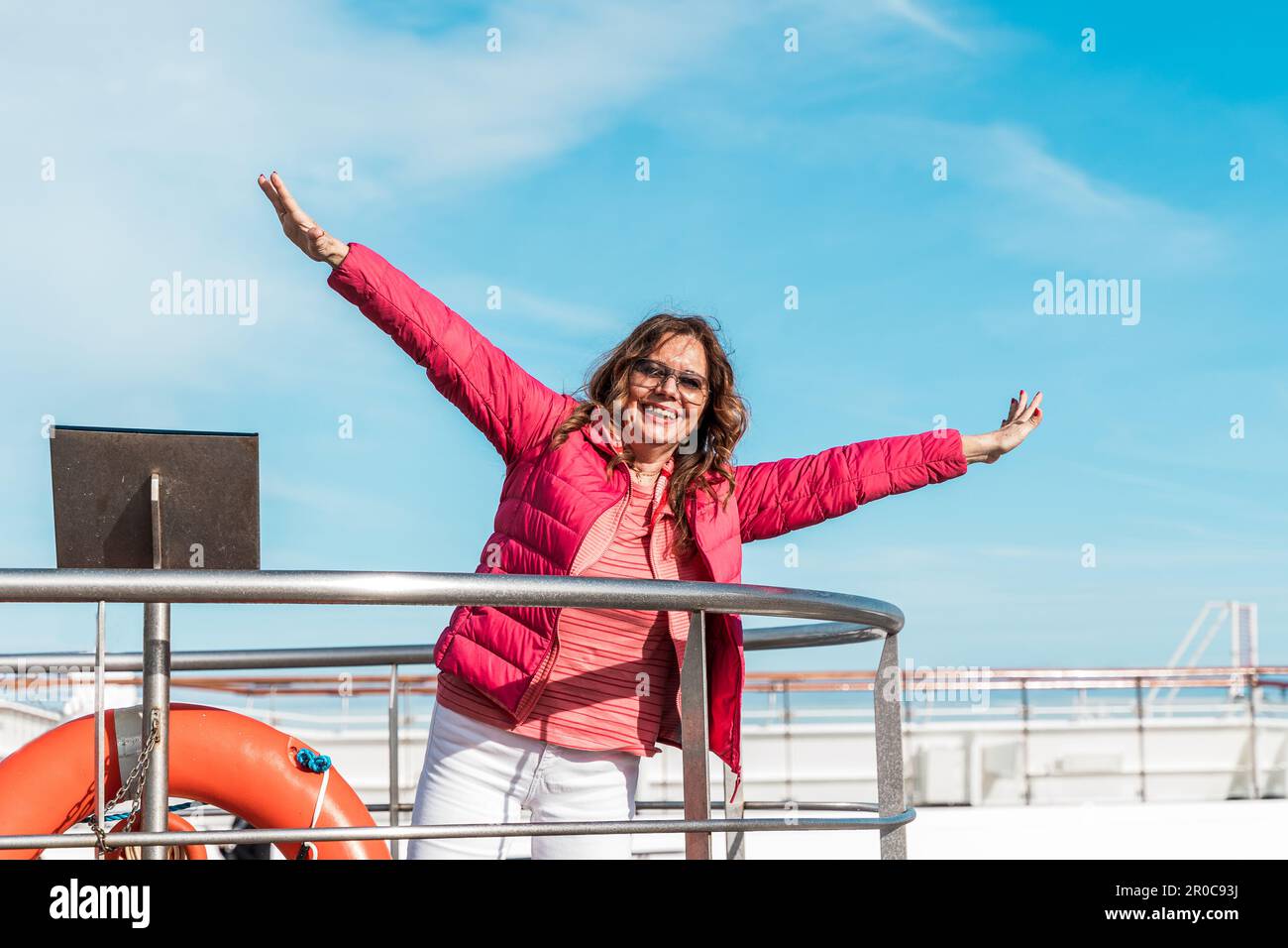 beautiful happy middle aged woman having fun on the deck of a cruise ...