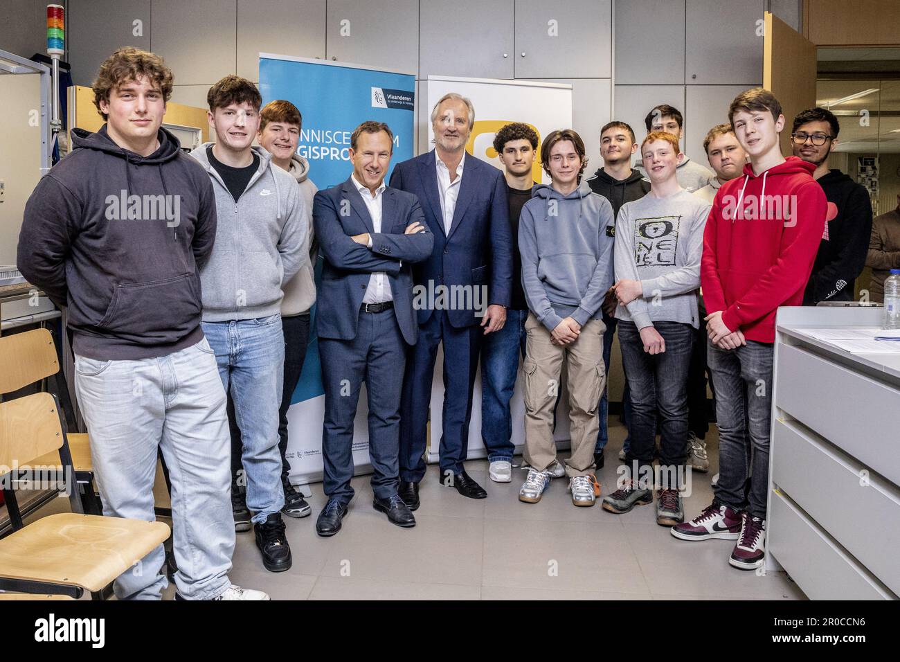 FOCUS COVERAGE REQUESTED TO BELGA - Telenet Business Vice-President Geert Degezelle and Telenet CEO John Porter and students pose for the photographer during a Press moment to launch a new stage in the Digisprong for schools, at the Technisch Instituut Don Bosco secondary school, in Halle, Monday 08 May 2023. It concerns a framework contract worth 40 million euros between Telenet and the Flemish government, to install fiber optic connections in Flemish schools. Credit: Belga News Agency/Alamy Live News Stock Photo