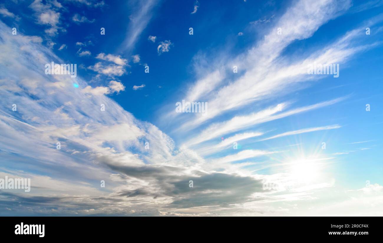 Blue sky with beautiful clouds and sun, sky landscape. Stock Photo