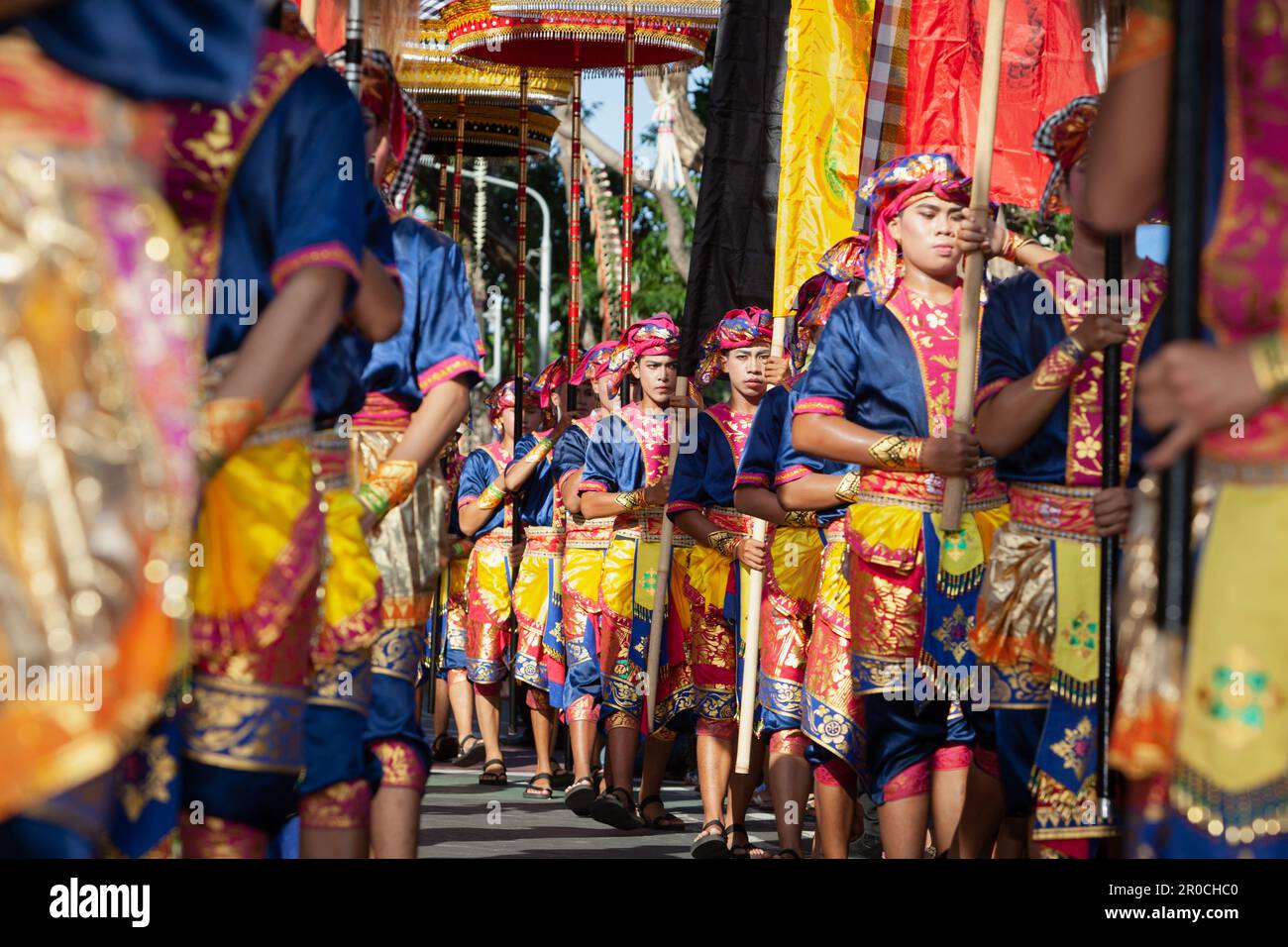Denpasar, Bali island, Indonesia - June 11, 2016: Young men dressed in ethnic Balinese people costume before dancing traditional ritual temple dance Stock Photo