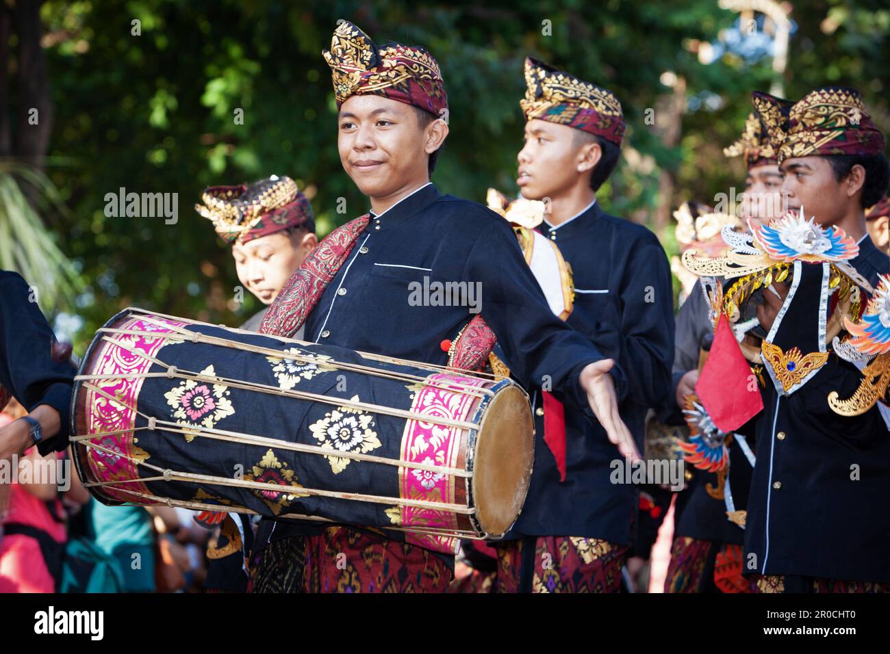 Denpasar, Bali island, Indonesia - June 11, 2016: Young musicians dressed in ethnic Balinese people costumes play traditional orchestra music Stock Photo