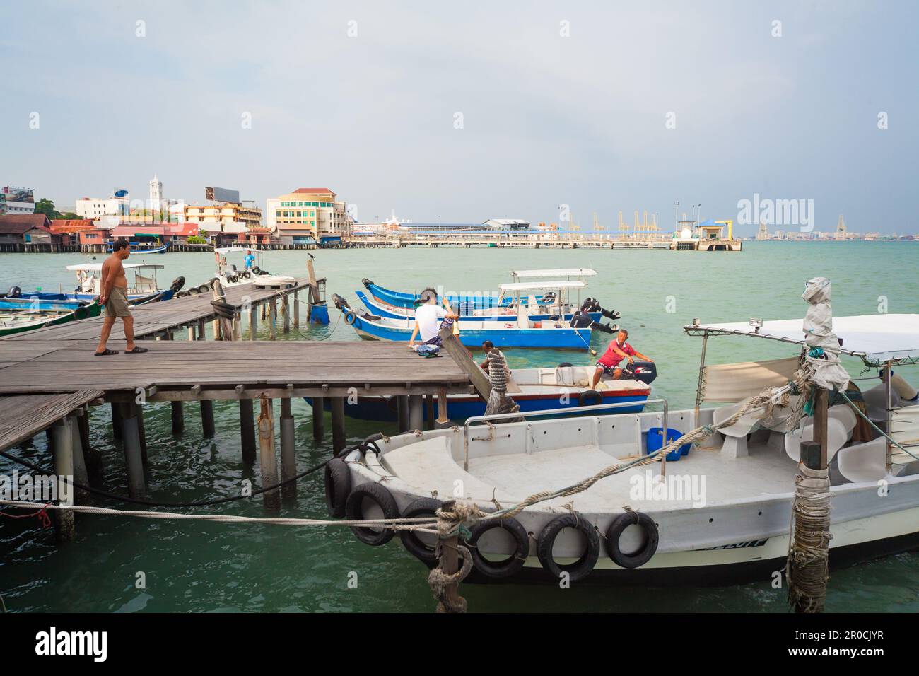 Georgetown, Penang, Malaysia - September 03, 2014: Pier on stilts with boats in Chew Jetty sea floating village in historical Georgetown, Penang, Stock Photo
