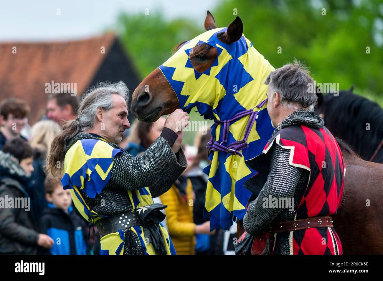 Knight Getting Coronated Chalfont, UK. 8 May 2023. A re enactor as an armoured knight unsaddling ...