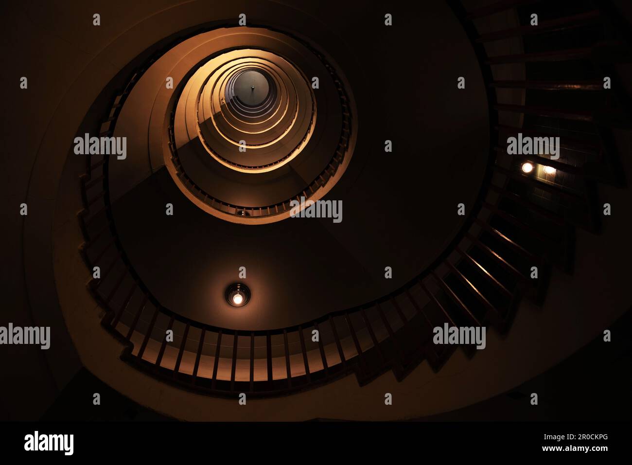 Spiral staircase in a tall multi-floor house, in the form of a 'golden ratio', architecture, concert Stock Photo