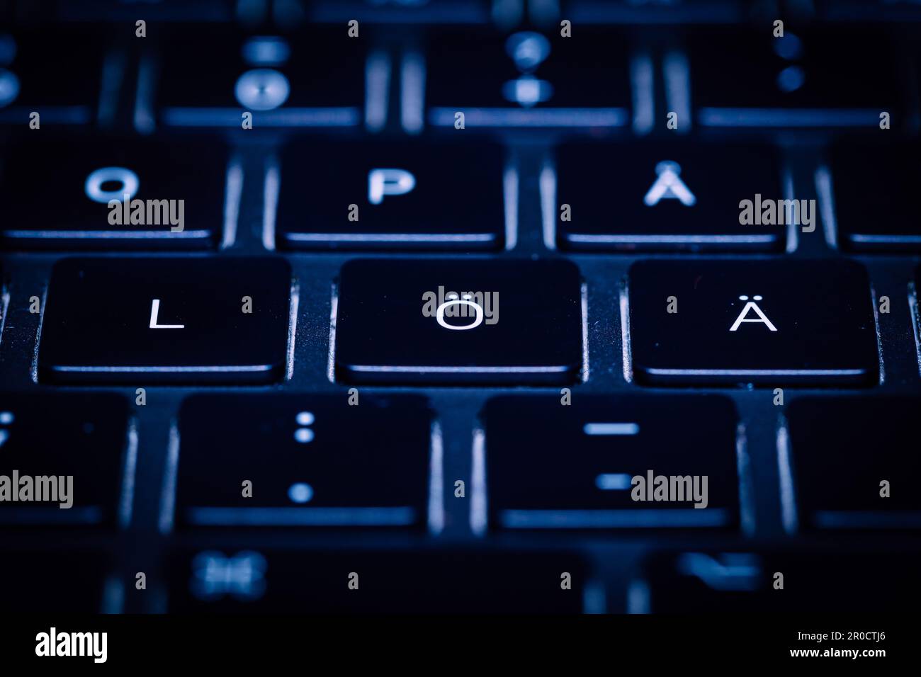 Swedish language keyboard with white lettering, keys and their corresponding characters Stock Photo