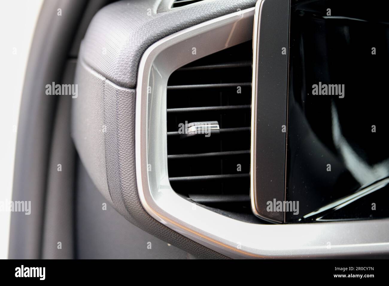 Close up modern heat vent inside car near car display screen Stock