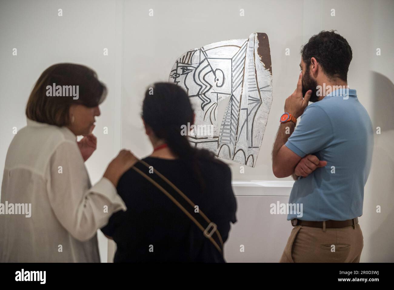 People seen looking at a sculpture during the presentation of the new exhibition 'Picasso Sculptor: Matter and Body' at the Picasso Museum in Malaga. As part of activities to commemorate the 50th anniversary of Picasso's death, the museum has organized different events and exhibitions throughout the year 2023, known as 'Picasso year.' The new exhibition showcases Picasso's facet as a sculptor, featuring sculptures that represent the human body using uncommon materials and techniques. This exhibition will run From May 9 to 10 Sept. (Photo by Jesus Merida/SOPA Images/Sipa USA) Stock Photo