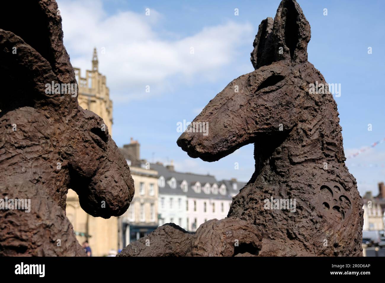 Around Cirencester a small town in the Cotswolds UK A sophie Ryder sculpture pink lady dancing with brown dog Stock Photo