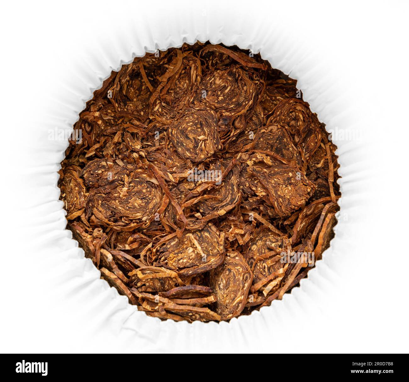 Closeup shot of rolled pipe tobacco flakes seen from above Stock Photo