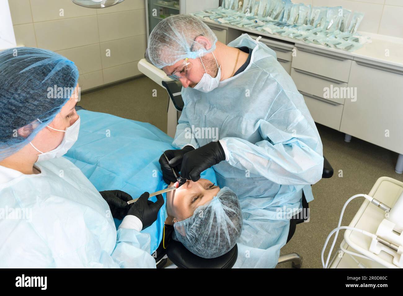 Surgeon and nurse during dental operation. Local anesthetized female