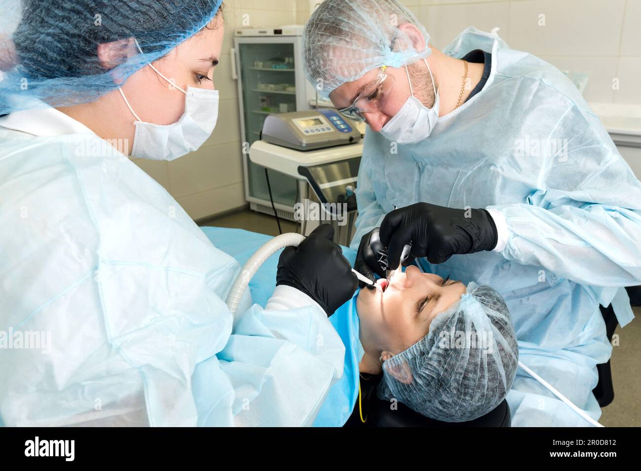 Surgeon and nurse during dental operation. Local anesthetized female