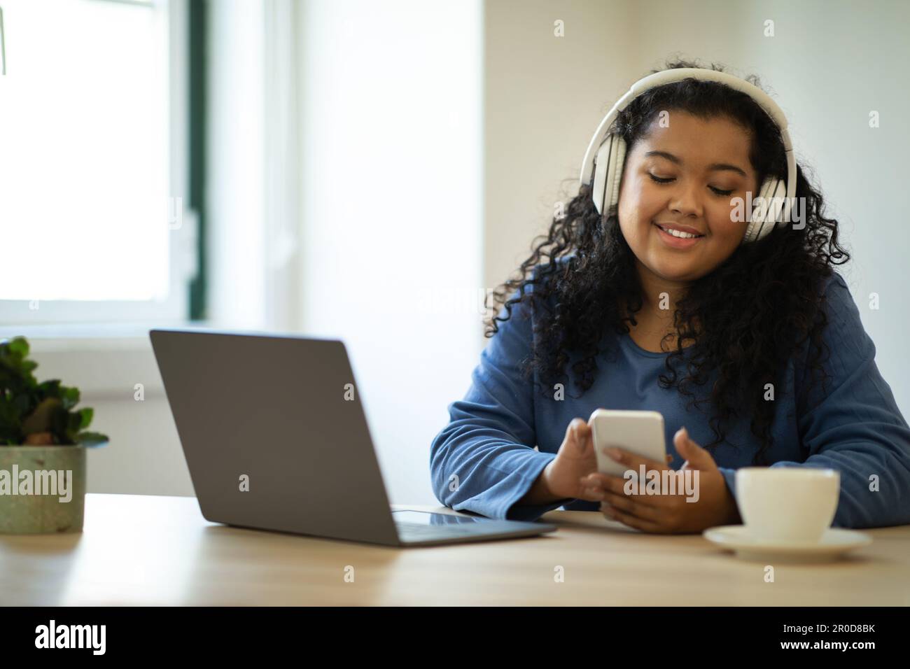 Happy young woman freelancer working from home, have break Stock Photo