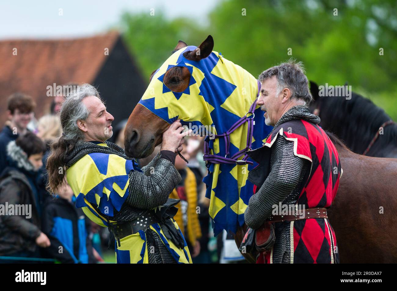 Knight Getting Coronated Chalfont, UK. 8 May 2023. A re enactor as an armoured knight unsaddling ...