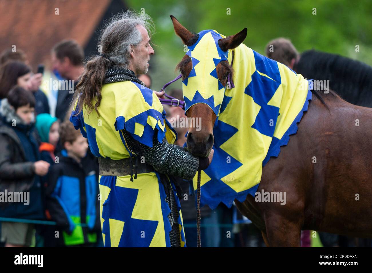 Chalfont, UK. 8 May 2023. A re enactor as an armoured knight unsaddling
