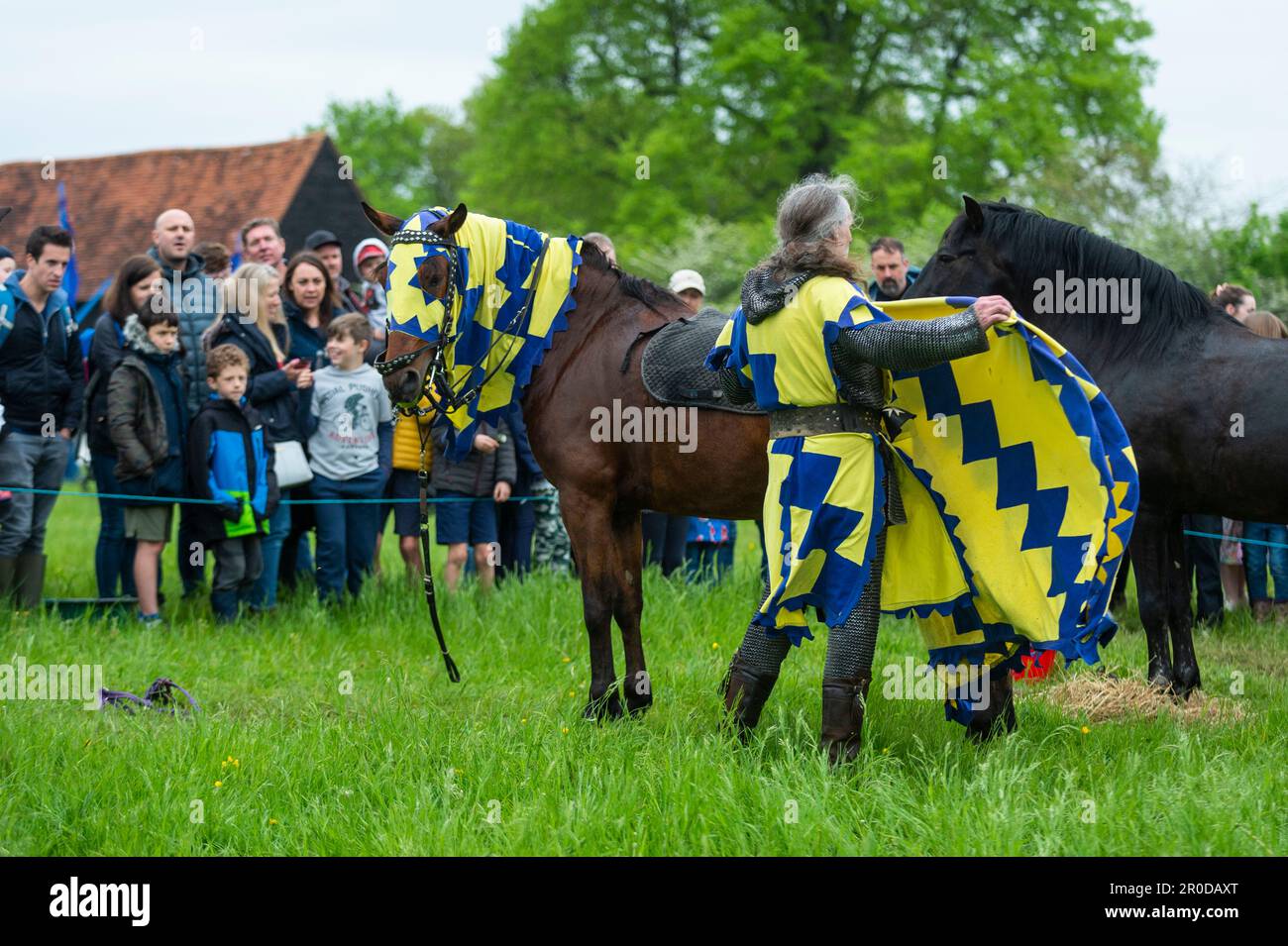 Chalfont, UK. 8 May 2023. A re enactor as an armoured knight unsaddling