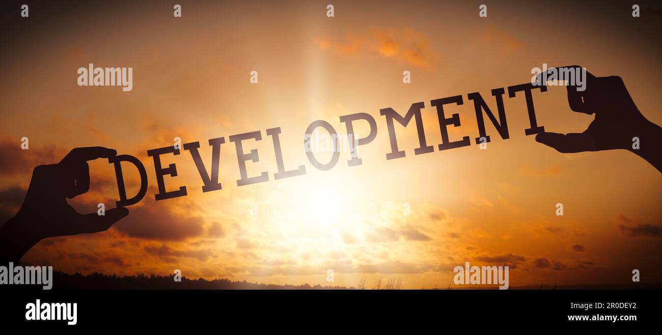 Development - human hands holding black silhouette word Stock Photo - Alamy