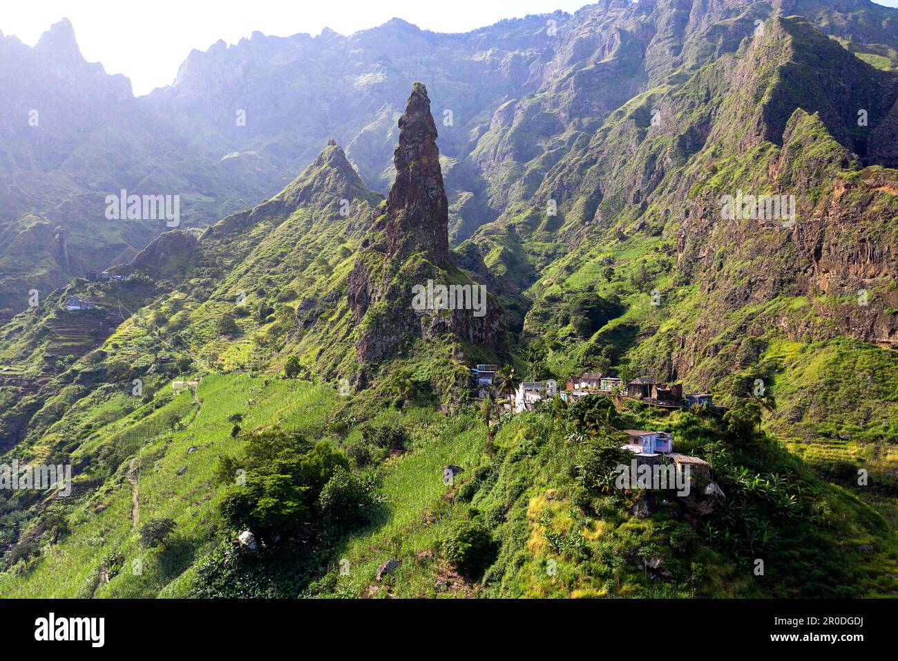Village surrounded big green mountains hi-res stock photograph…
