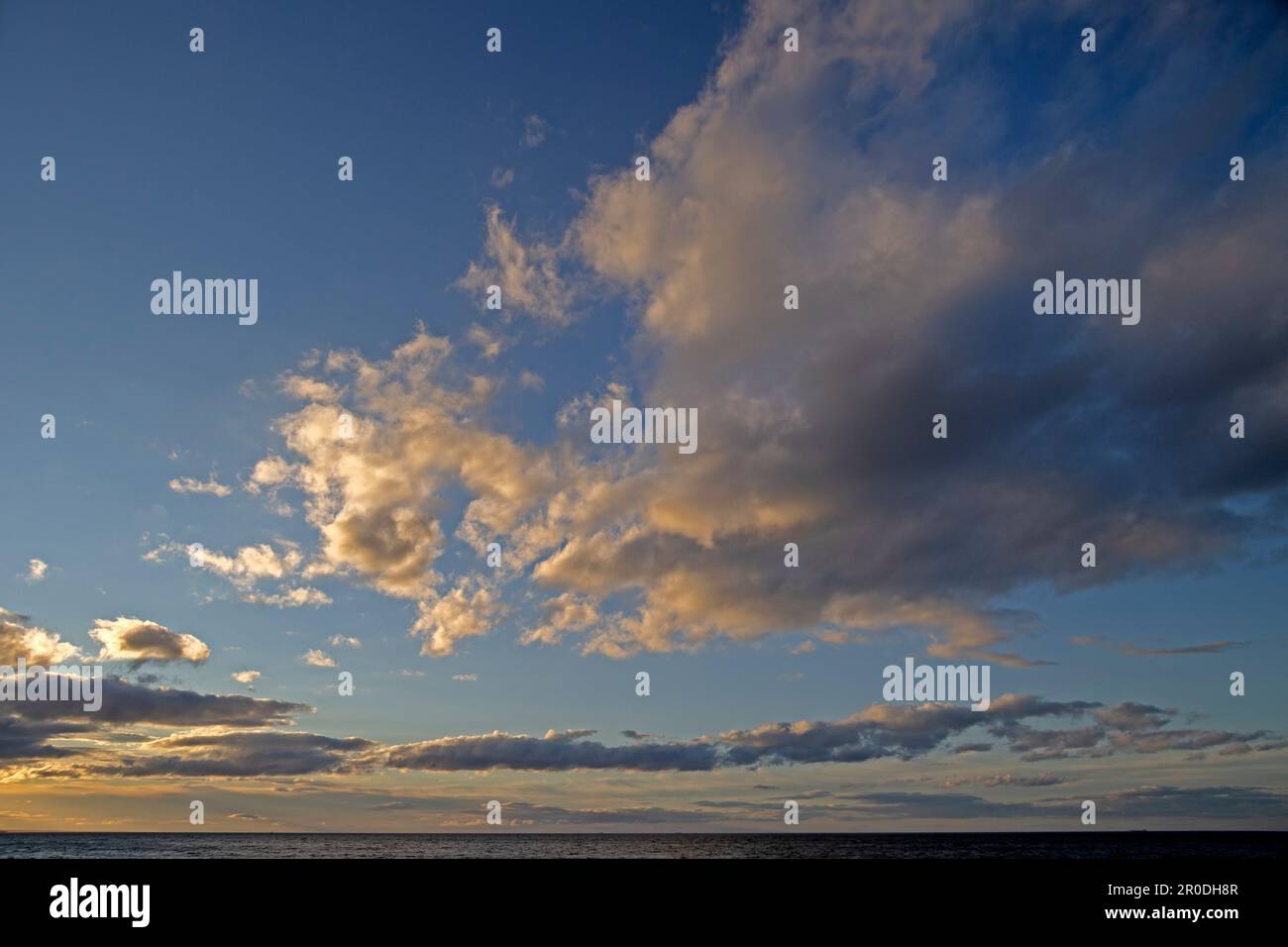 Sky scene over sea at sunset Stock Photo
