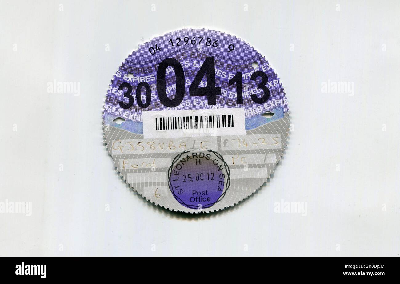 Old UK paper vehicle tax disks which used to be displayed on the windscreen to prove that excise duty had been paid. The disks were discontinued in 2014 in favour of computerised checks. Stock Photo